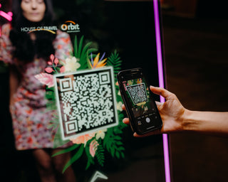 girl scanning a QR code on a photo booth screen